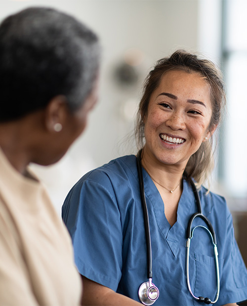 Female nurse smiling at senior